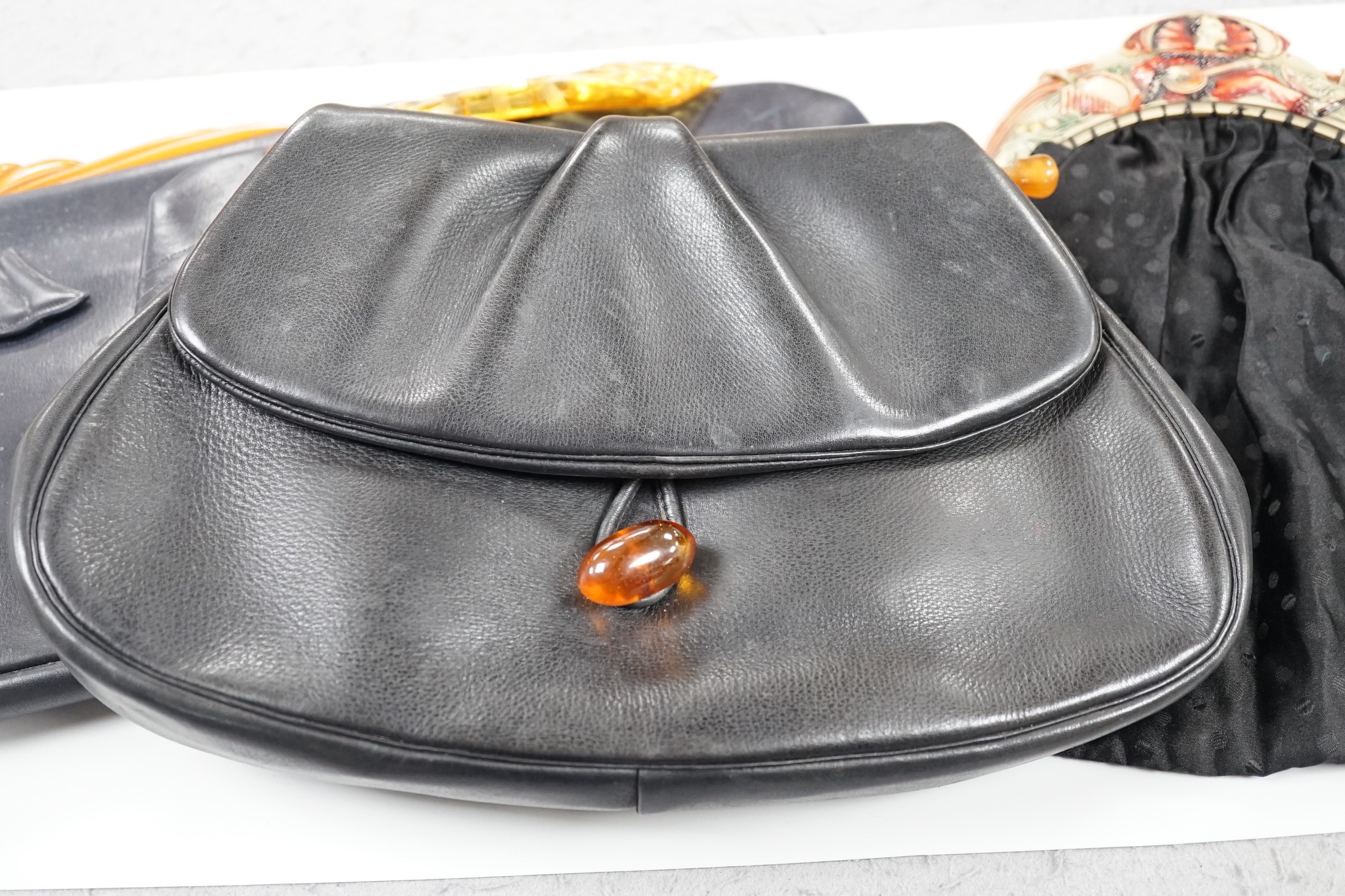 A 1930's Pierrot bakelite bag frame, together with three 1930's yellow bakelite and leather clutch bags (4)